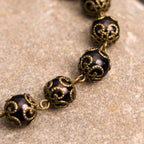 Pulsera Rosario Retro Negra con Medalla de San Benito y Crucifijo
