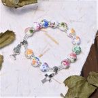 Pulsera de Una Decena de Cuentas de Cerámica de Colores con Santo Cáliz