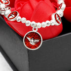 Pulsera de Cuentas de Rosa y Cruz con Espíritu Santo en Esmalte: Símbolo de Protección Bendita