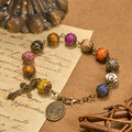 Pulsera Vintage de Cuentas de Colores con San Benito y Crucifijo en Bronce: Confianza en lo Divino