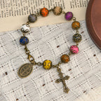Pulsera Vintage de Cuentas de Colores con San Benito y Crucifijo en Bronce: Confianza en lo Divino