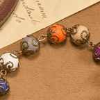 Pulsera Vintage de Cuentas de Colores con San Benito y Crucifijo en Bronce: Confianza en lo Divino