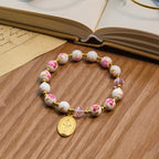 Pulsera Elegante de Cerámica Rosa de 8 mm con Patrón Floral y Medalla Milagrosa