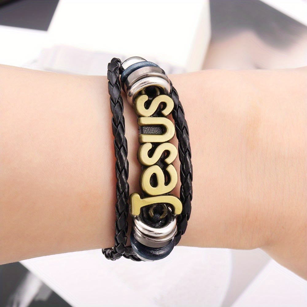 Pulsera de Cuero Trenzado Negro con Dije de Jesús en Dos Tonos