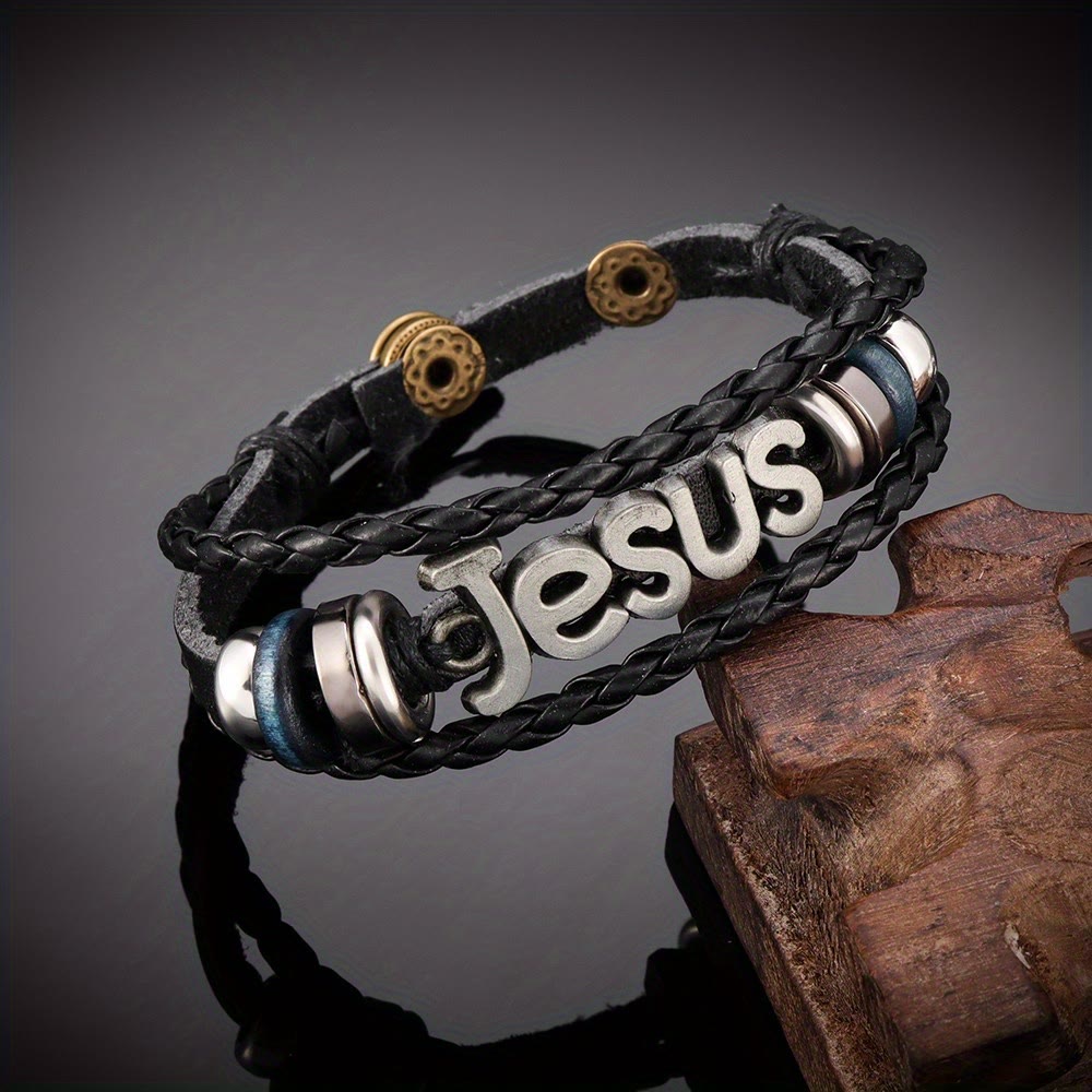 Pulsera de Cuero Trenzado Negro con Dije de Jesús en Dos Tonos