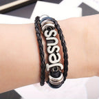 Pulsera de Cuero Trenzado Negro con Dije de Jesús en Dos Tonos