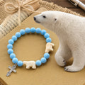 Pulsera Artesanal de Cruz con Cuentas Azules Oso Polar: Salvemos a los Osos Polares