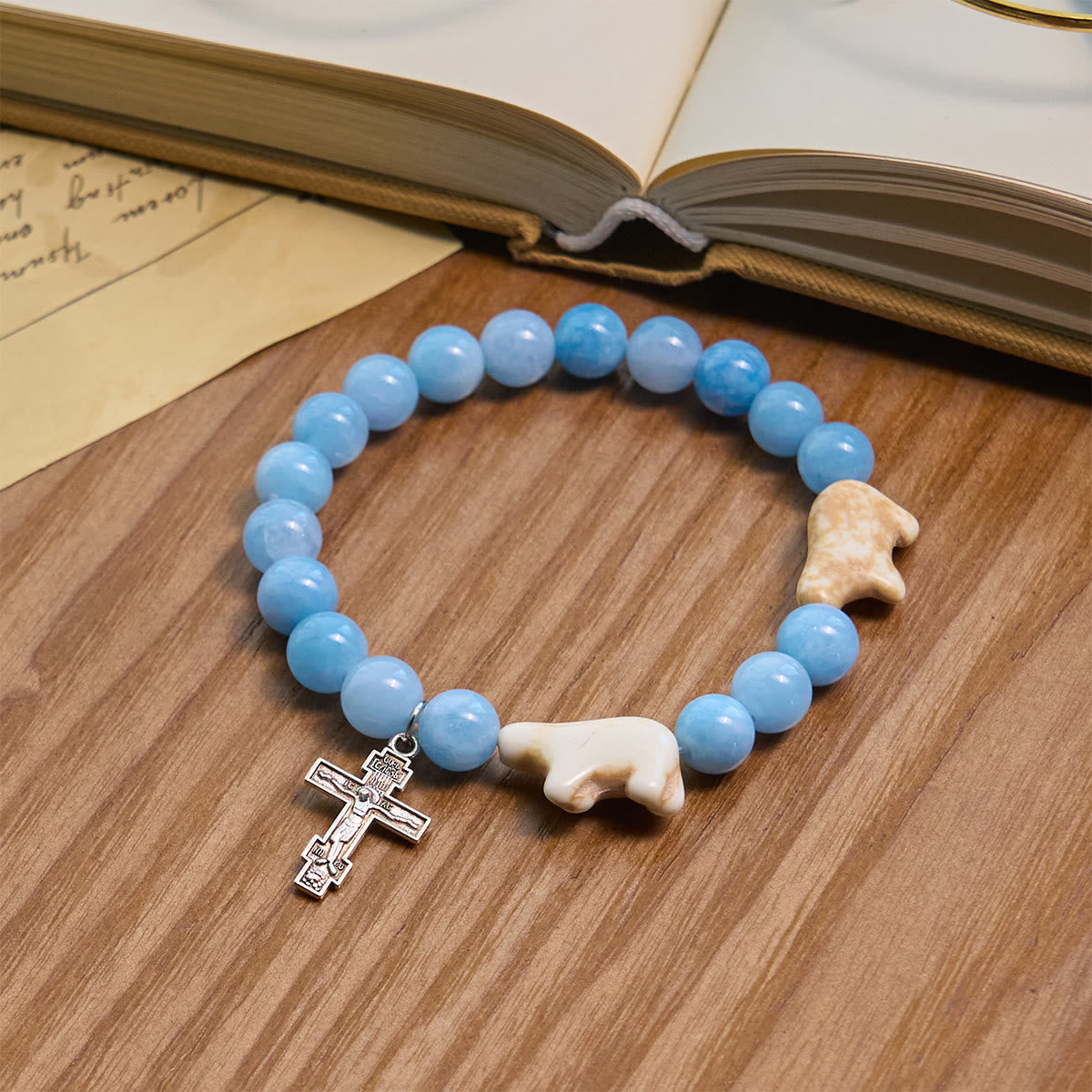 Pulsera Artesanal de Cruz con Cuentas Azules Oso Polar: Salvemos a los Osos Polares