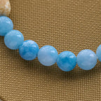 Pulsera Artesanal de Cruz con Cuentas Azules Oso Polar: Salvemos a los Osos Polares