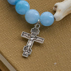 Pulsera Artesanal de Cruz con Cuentas Azules Oso Polar: Salvemos a los Osos Polares